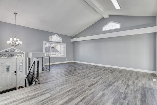 interior space with beamed ceiling, wood-type flooring, high vaulted ceiling, and an inviting chandelier