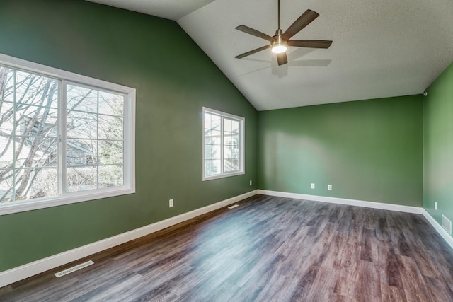 unfurnished room with ceiling fan, dark wood-style flooring, visible vents, and baseboards