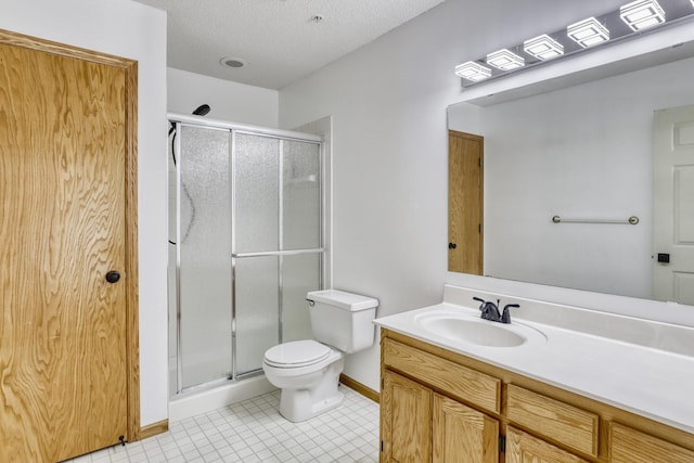 full bathroom featuring toilet, a stall shower, a textured ceiling, vanity, and tile patterned flooring