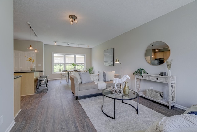 living room with a textured ceiling and dark hardwood / wood-style flooring