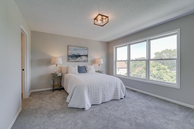 bedroom with carpet flooring and a textured ceiling