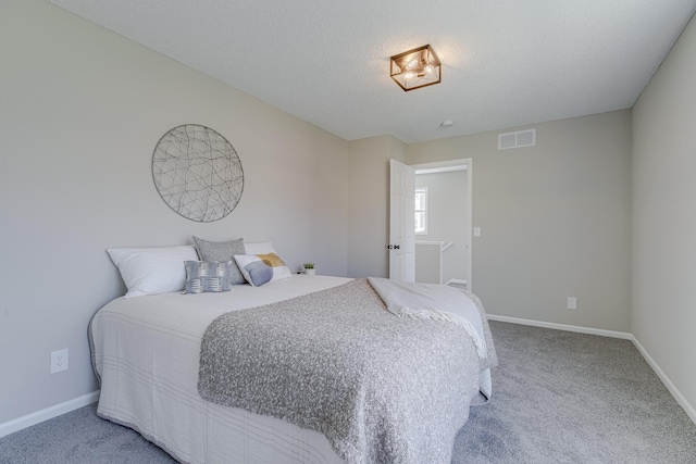 bedroom with carpet flooring and a textured ceiling