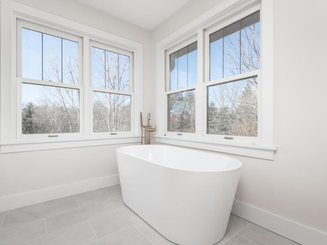 bathroom with a bath and tile patterned flooring