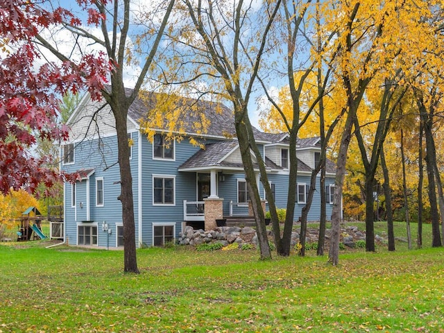 view of front of home featuring a front lawn and a playground