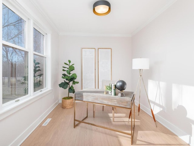 home office featuring crown molding and light hardwood / wood-style floors