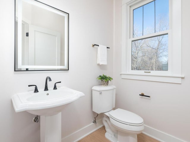 bathroom with hardwood / wood-style flooring, sink, and toilet