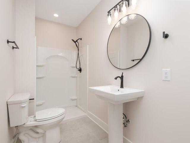 bathroom with walk in shower, sink, toilet, and tile patterned flooring