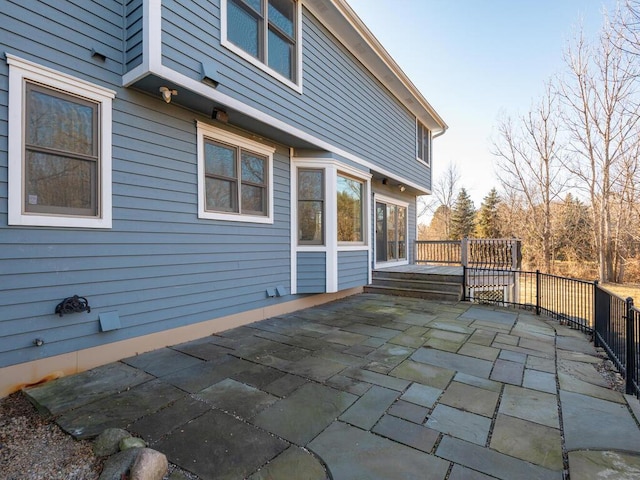 view of home's exterior featuring a patio and a deck