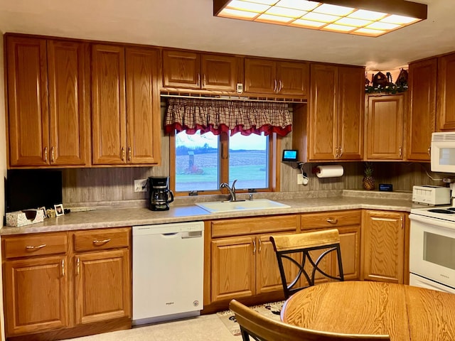 kitchen featuring sink, white appliances, and a water view