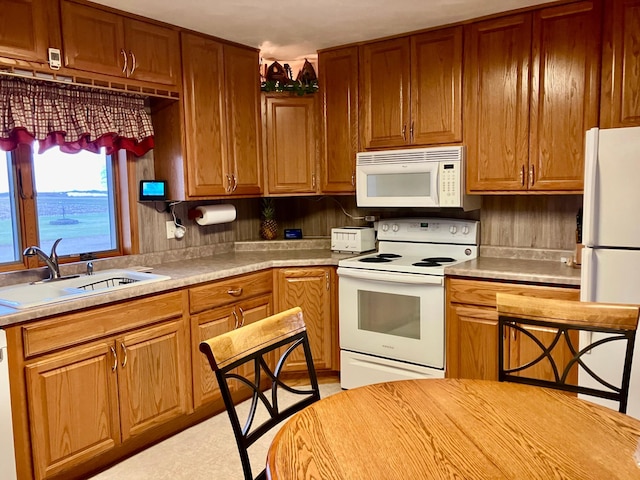 kitchen with sink and white appliances