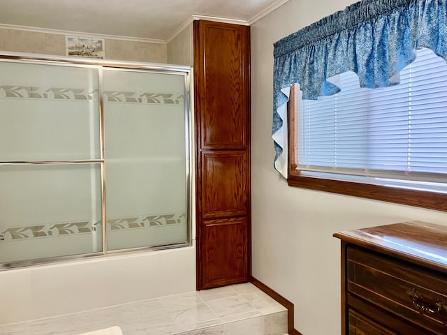 bathroom with ornamental molding and combined bath / shower with glass door