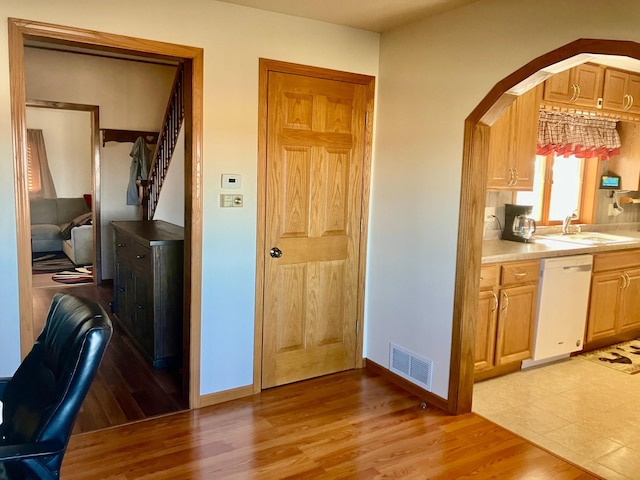 kitchen with sink, light hardwood / wood-style flooring, and dishwasher