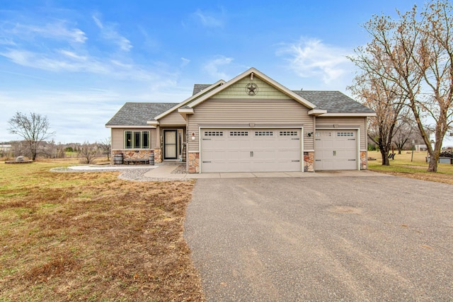 craftsman-style house featuring a garage and a front yard