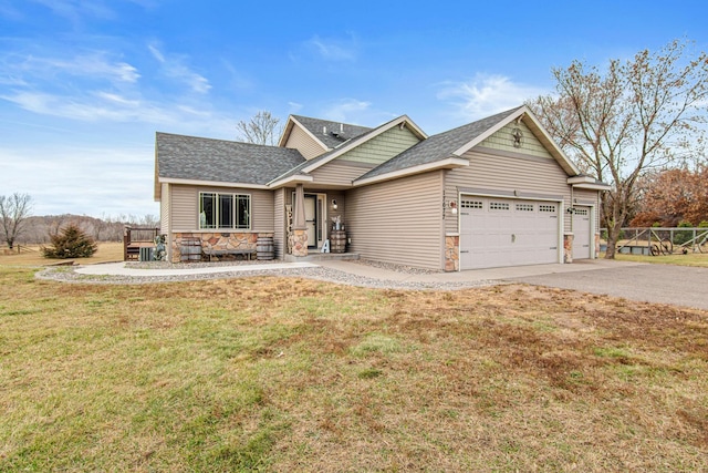 craftsman-style home featuring a garage and a front yard