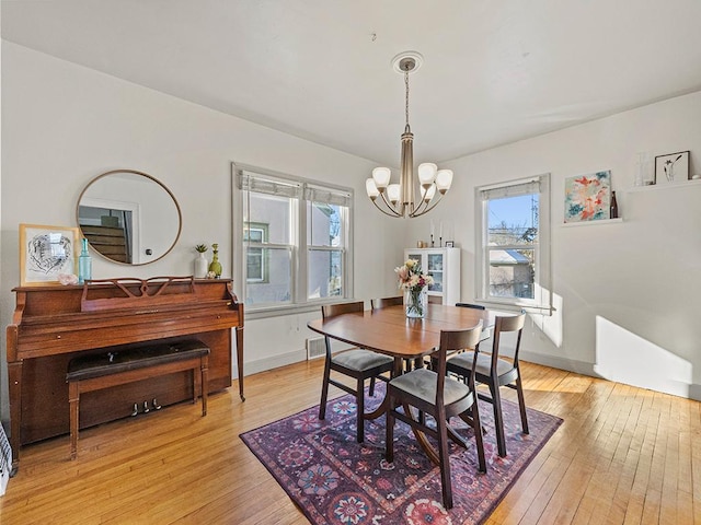 dining room featuring an inviting chandelier and light hardwood / wood-style floors