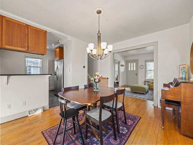 dining room featuring a chandelier and light hardwood / wood-style floors