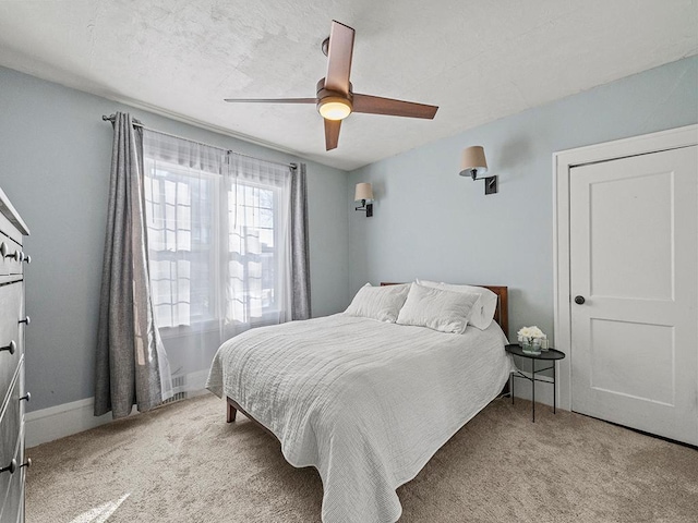 bedroom with ceiling fan and light carpet