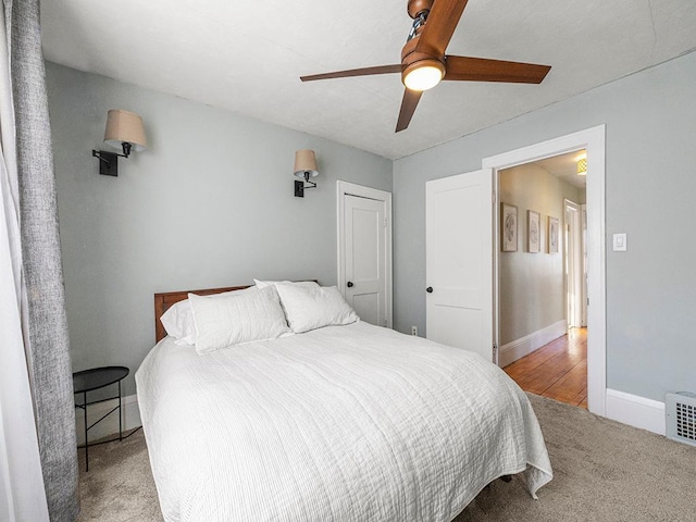 bedroom with ceiling fan and light colored carpet