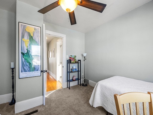 bedroom with light carpet and ceiling fan