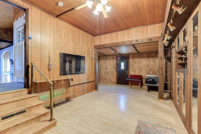 living room featuring ceiling fan, wooden walls, hardwood / wood-style floors, and wood ceiling