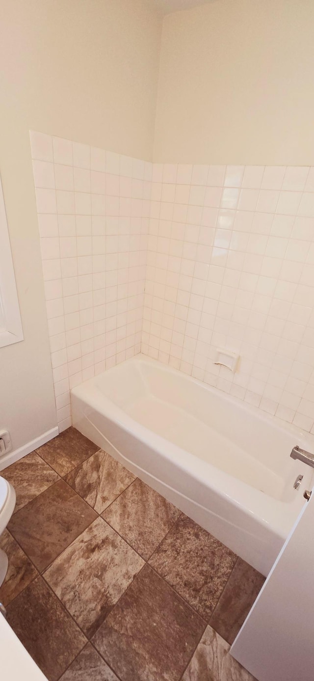 bathroom featuring a bathtub and toilet