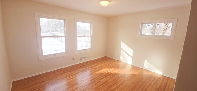 spare room featuring light hardwood / wood-style flooring