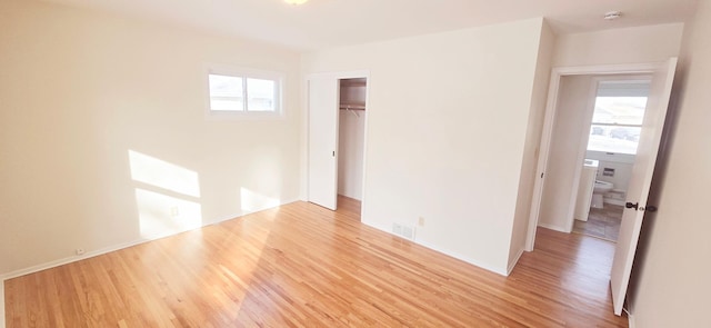 spare room with plenty of natural light and light wood-type flooring