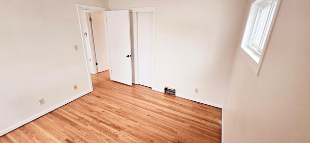 empty room with light hardwood / wood-style flooring