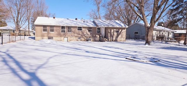 view of snow covered back of property