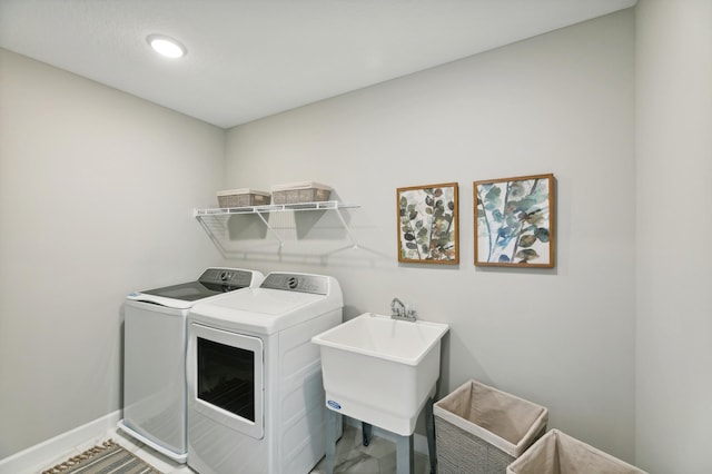 washroom featuring sink and independent washer and dryer