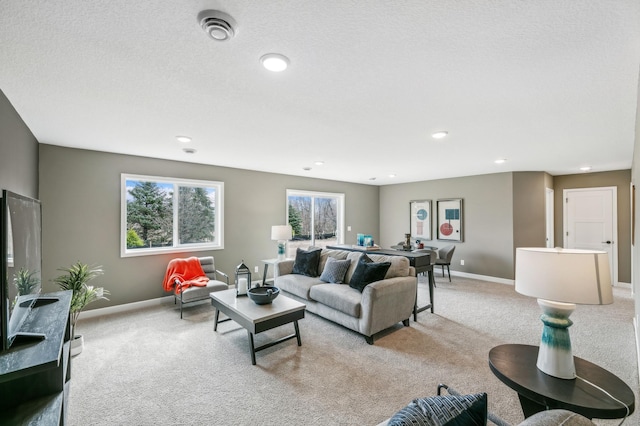 carpeted living room with a textured ceiling