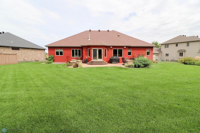 rear view of property featuring a yard and a patio