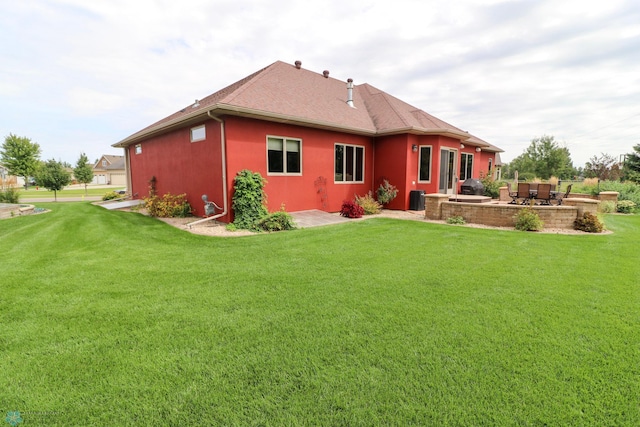 rear view of property with a lawn and a patio