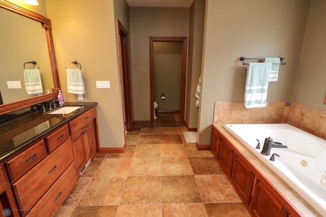 bathroom with toilet, vanity, and a tub to relax in