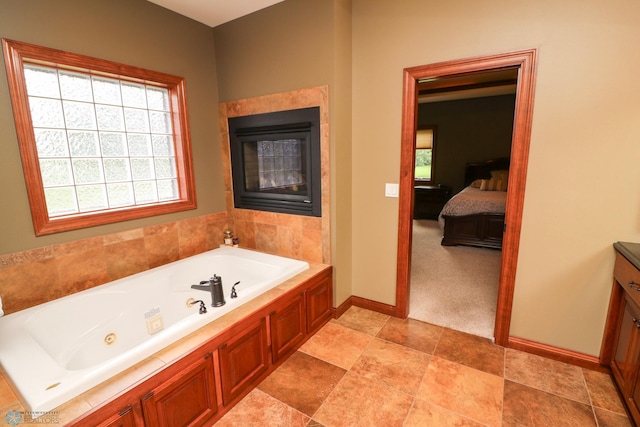 bathroom with a washtub and vanity