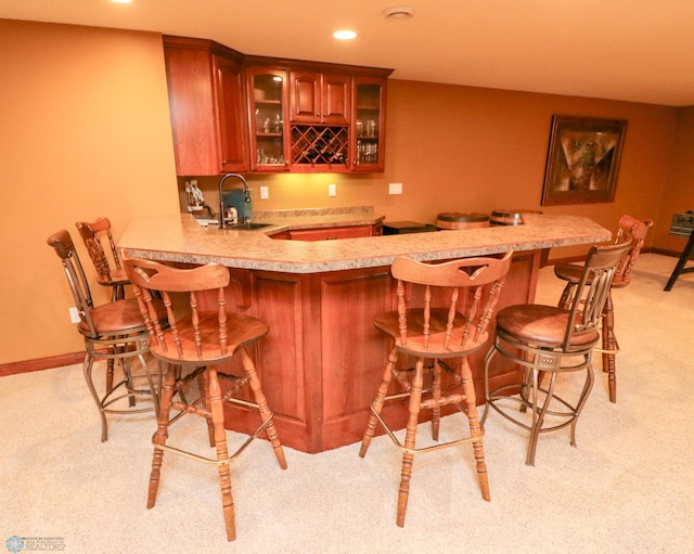 bar with sink and light carpet