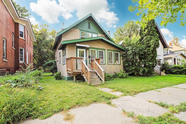 bungalow-style house with a front lawn