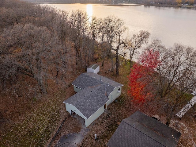 aerial view at dusk featuring a water view