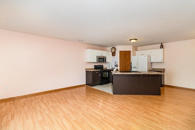 kitchen with black electric range oven, white cabinets, a center island, white fridge with ice dispenser, and light hardwood / wood-style floors