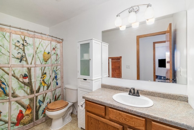 bathroom featuring vanity, toilet, and walk in shower