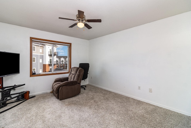 living area featuring carpet and ceiling fan