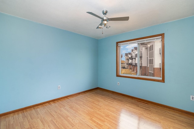 empty room with light hardwood / wood-style floors and ceiling fan