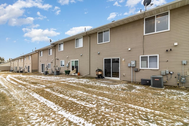 snow covered property with cooling unit