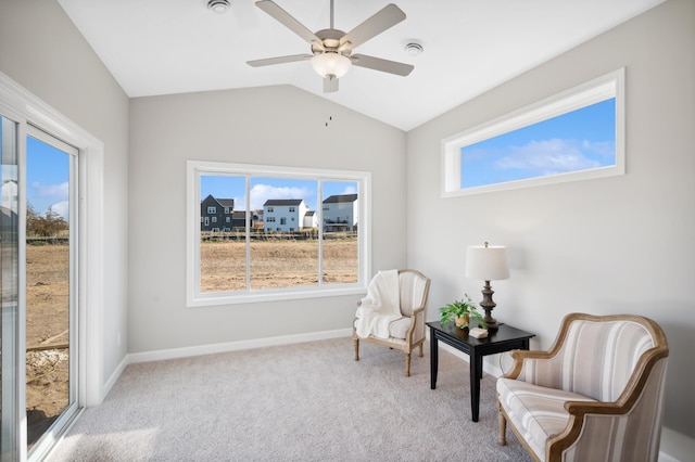 sitting room featuring vaulted ceiling, plenty of natural light, light carpet, and ceiling fan