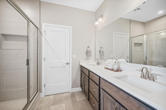 bathroom featuring an enclosed shower, vanity, and hardwood / wood-style flooring