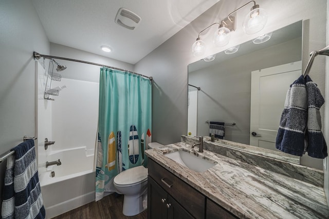 full bathroom featuring vanity, hardwood / wood-style floors, shower / bath combination with curtain, and toilet