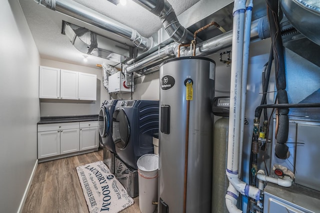 laundry room with cabinets, dark hardwood / wood-style flooring, separate washer and dryer, and electric water heater