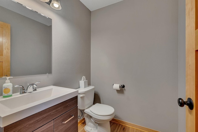 bathroom featuring vanity, toilet, and wood-type flooring