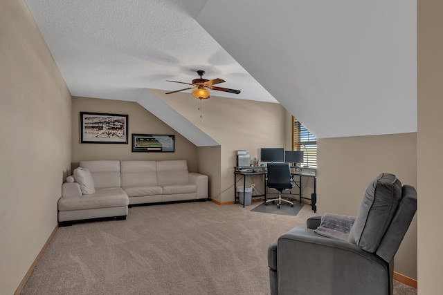 office area with lofted ceiling, a textured ceiling, light colored carpet, and ceiling fan