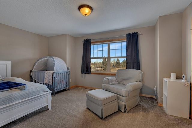 bedroom with carpet and a textured ceiling